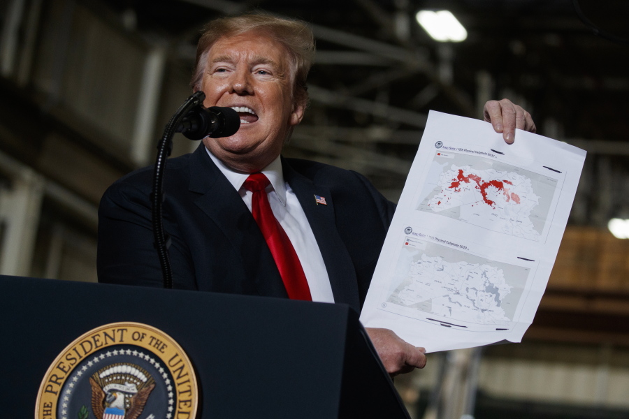 President Donald Trump holds up a chart documenting ISIS land loss in Iraq and Syria as delivers remarks at the Lima Army Tank Plant, Wednesday, March 20, 2019, in Lima, Ohio. In a campaign that spanned five years and two U.S. presidencies, the American military engineered the destruction of the Islamic State group’s self-proclaimed empire in Iraq and Syria. That’s a military success, but not one that’s certain to last.