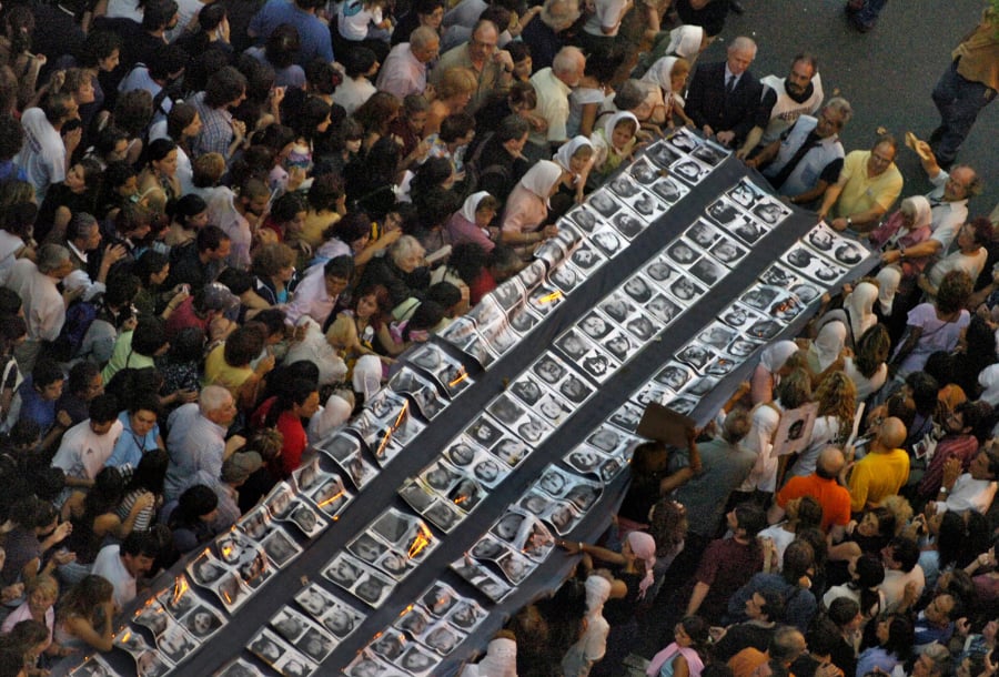 Demonstrators hold a big banner with pictures of the missing people during a march from the National Congress to Plaza de Mayo in Buenos Aires in March 2006 during the 30th anniversary of the coup which started the most bloody dictatorship (1976-1983) in Argentina.