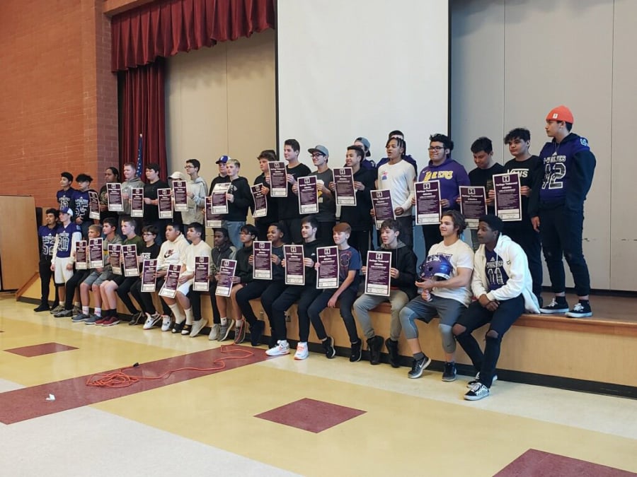 Eighth graders from Covington Middle School and Frontier Middle School hold up their commitment letters to the Heritage football program on Wednesday.