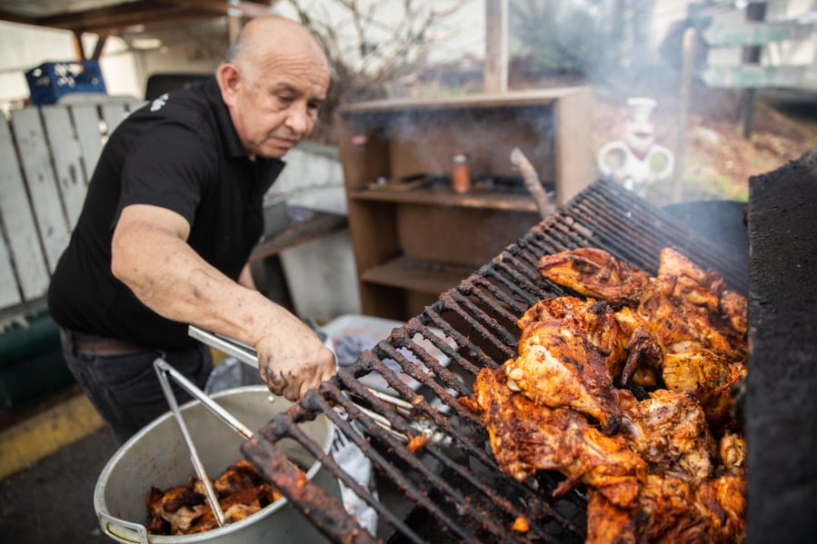 Juan Olguin Sr. grills chicken at Don Juan Corner Cafe, the restaurant he and his son Juan Olguin Jr. own and operate together in Vancouver. The elder Olguin starts preparing the weekend specials like pollo asado al carbon at 1 a.m.