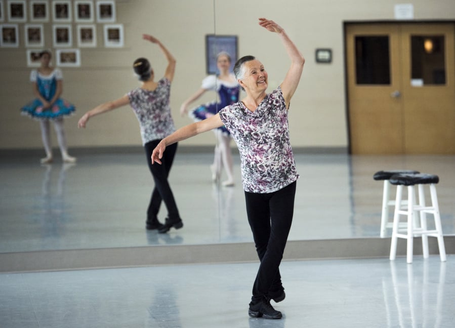 Jan Hurst, artistic director at Columbia Dance, works with students Ainsley de Guzman, 15, left, and Kirstin Pierson, 14, for an upcoming production of “Excerpts From Swan Lake.” The spring showcase will be Hurst’s final one for Columbia Dance, before she retires in June as artistic director, after 23 years.