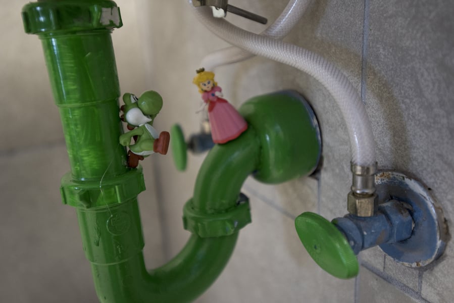 Super Mario video game characters are seen on the sink pipes in a bathroom at Vault 31.