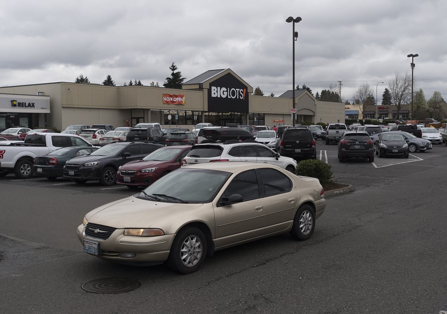 A motorist drives through a packed parking lot at the new Big Lots in Orchards that opened April 4.