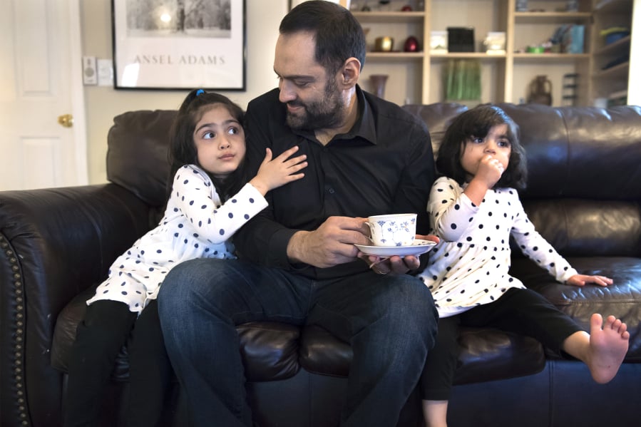 Sana Mir, 4, from left, tries to get another sip of her dad’s tea, as Ahsan Mir, 50, and Asiya Mir, 2, watch a show after dinner at their Vancouver home. Ahsan was diagnosed with kidney failure about eight years ago, but he ignored his diagnosis until recently. Now he’s trying to seek help through a kidney transplant.
