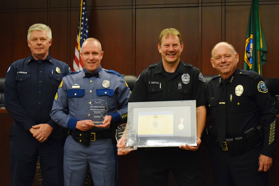 From left to right: Fire District 3 Chief Scott Sorenson, Washington State Patrol Sgt. Stephen Robley, Battle Ground police officer Ed Michael and Police Chief Bob Richardson during a recent awards ceremony.
