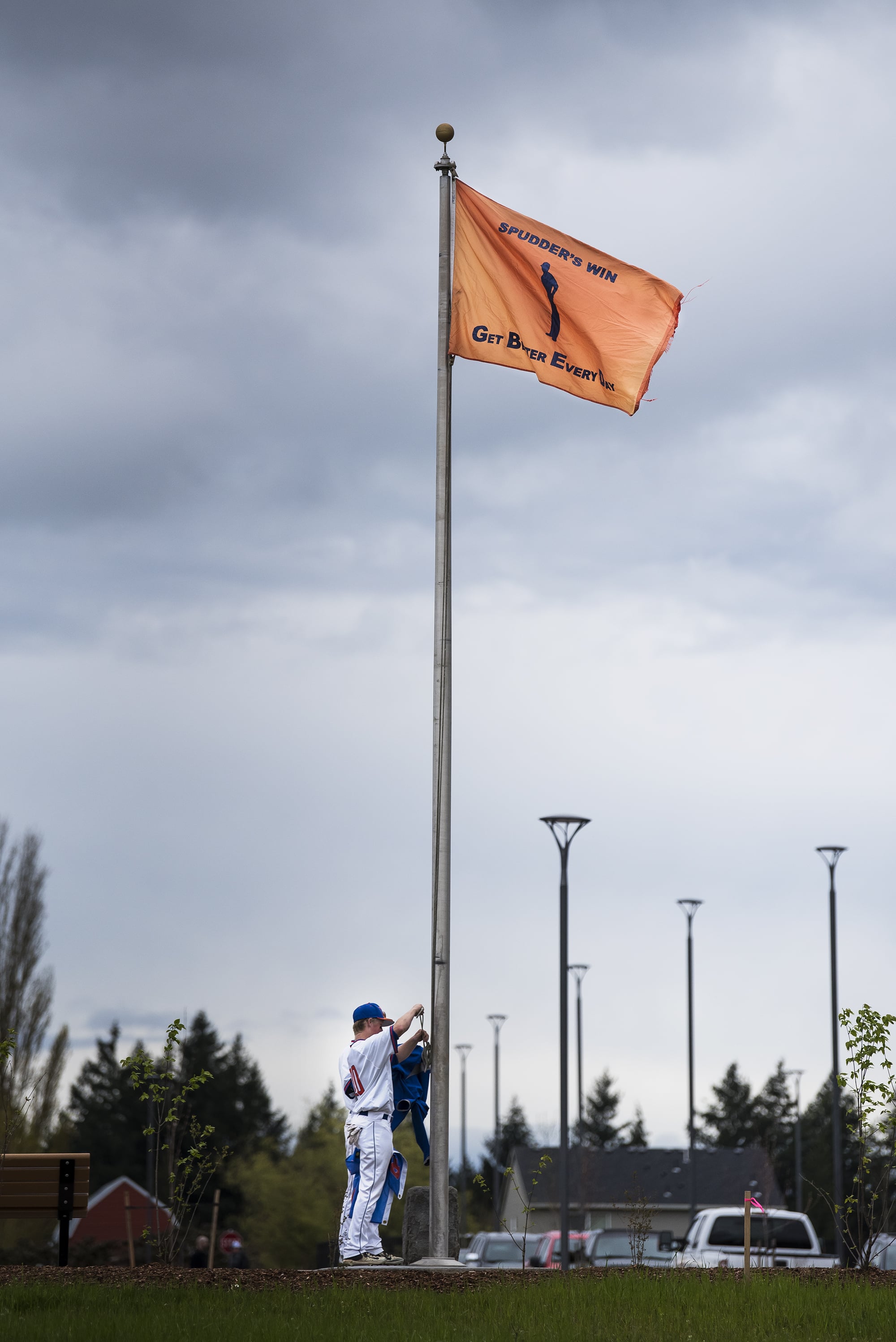 Ridgefield players raise a flag declaring a Spudders’ Victory following their win over Columbia River at the Ridgefield Outdoor Recreation Center on Tuesday night, April 16, 2019.
