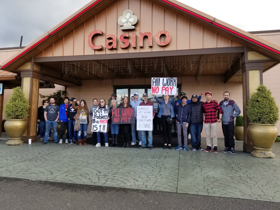 Former Lucky 21 casino employees line up outside the entrance Friday. The casino closed the morning of April 8, which was supposed to be a payroll day.