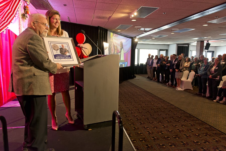 Ed Barnes, 2019 Clark County First Citizen, is honored at WareHouse '23 by Jennifer Rhoads, president of the Community Foundation for Southwest Washington. Photo by James Rexroad for The Columbian.