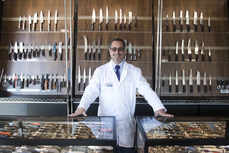 Dennis Epstein, owner of Apogee Culinary Designs, stands in the gallery at his new Hazel Dell knife store. The store sells several brands of kitchen and pocket knives, as well as a selection of restored and refinished knives that customers have traded.