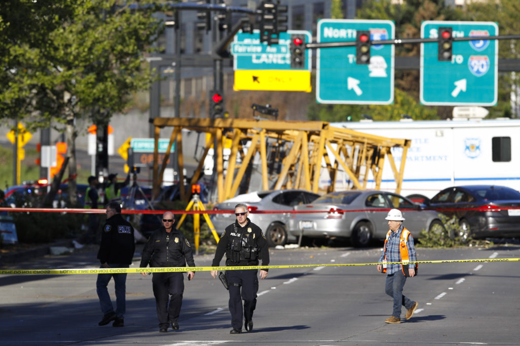Emergency crews work at the scene of a construction crane collapse where several people were killed and others were injured Saturday, April 27, 2019, in the South Lake Union neighborhood of Seattle. The crane collapsed near the intersection of Mercer Street and Fairview Avenue pinning cars underneath it near Interstate 5 shortly after 3 p.m.