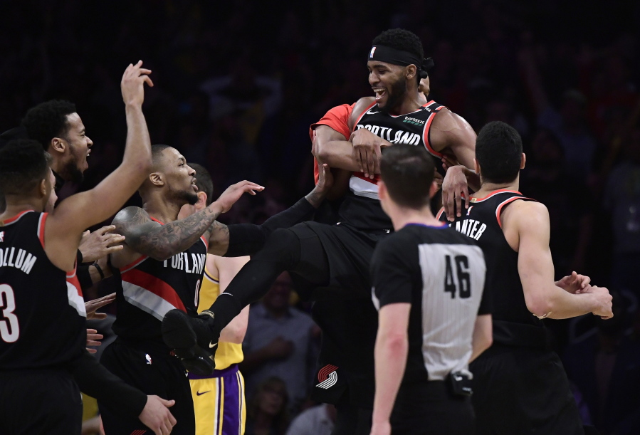 Portland Trail Blazers forward Maurice Harkless, upper right, celebrates with teammates after making a game-winning 3-point shot at the buzzer in the team’s NBA basketball game against the Los Angeles Lakers on Tuesday, April 9, 2019, in Los Angeles. The Trail Blazers won 104-101. (AP Photo/Mark J.