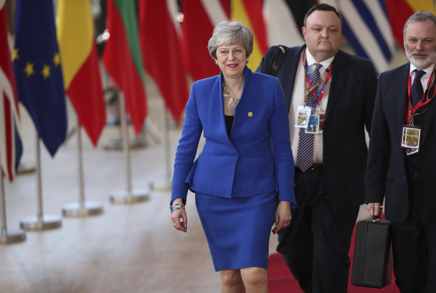 British Prime Minister Theresa May, left, arrives for an EU summit at the Europa building in Brussels, Wednesday, April 10, 2019. European Union leaders meet Wednesday in Brussels for an emergency summit to discuss a new Brexit extension.