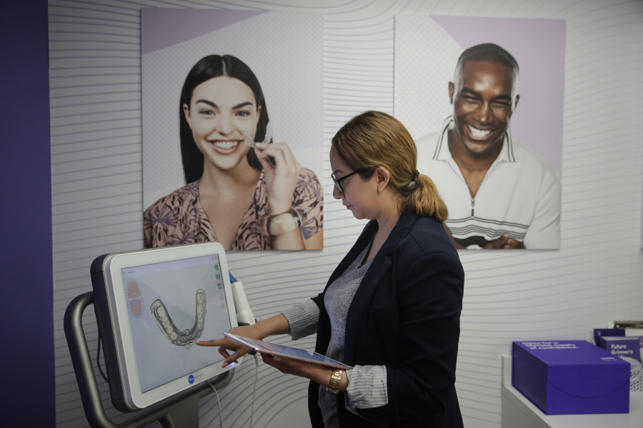 Dental assistant Jessica Buendia looks at a scanned image of a patient’s teeth on Wedneday in SmileDirectClub’s SmileShop inside a CVS store in Downey, Calif. Jae C.