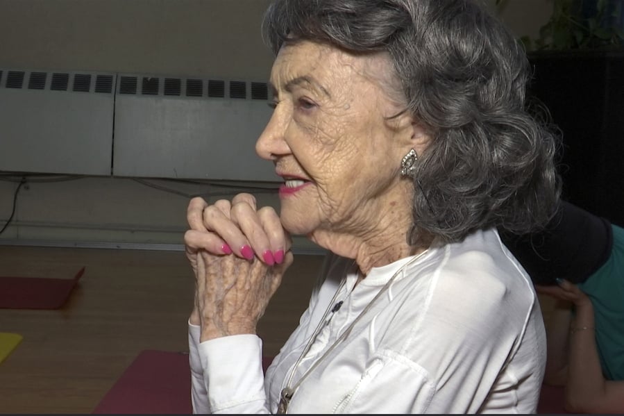 In this April 5, 2019, image made from a video, 100-year-old Tao Porchon-Lynch teaches a yoga class in Hartsdale, N.Y.