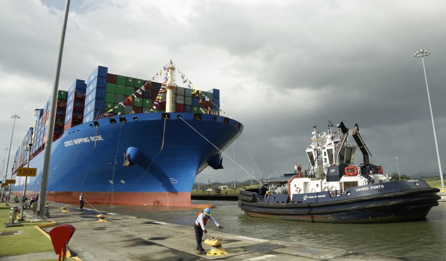 In this Dec. 3, 2018, photo, a Panama Canal worker docks the Chinese container ship Cosco at the Panama Canals’ Cocoli Locks, in Panama City. China’s expansion in Latin America of its Belt and Road initiative to build ports and other trade-related facilities is stirring anxiety in Washington. As American officials express alarm at Beijing’s ambitions in a U.S.-dominated region, China has launched a charm offensive, wooing Panamanian politicians, professionals, and journalists.