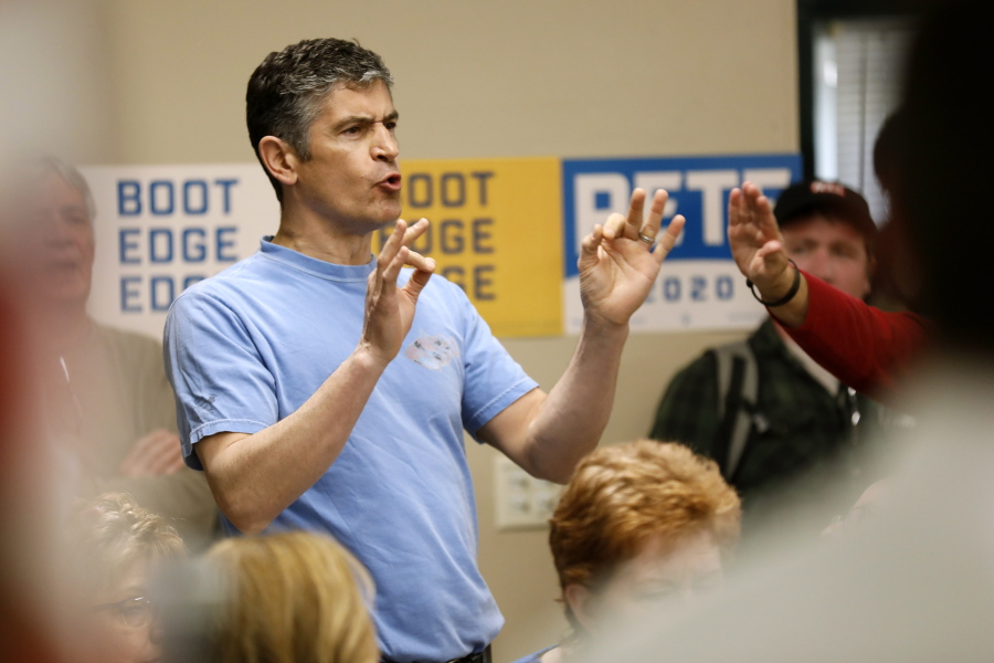 A protester shouts as 2020 Democratic presidential candidate, South Bend Mayor Pete Buttigieg speaks during a town hall meeting, Tuesday, April 16, 2019, in Fort Dodge, Iowa.