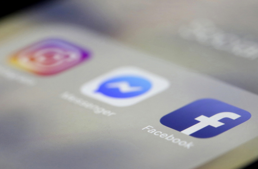 FILE- In this March 13, 2019, file photo Facebook, Messenger and Instagram apps are are displayed on an iPhone in New York. Facebook, Instagram and WhatsApp were temporarily down early Sunday, April 14. All three social media platforms, including Facebook Messenger, were affected by the outage.