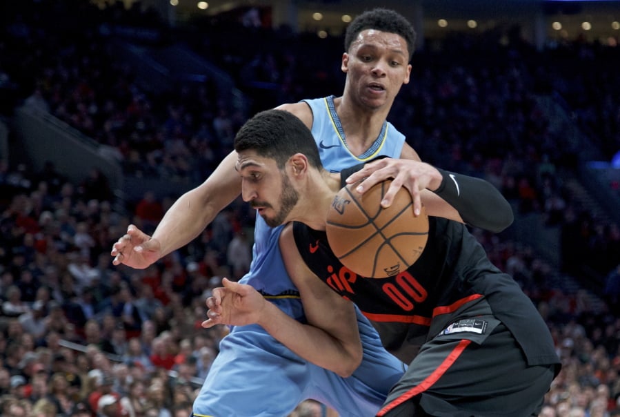 Portland Trail Blazers center Enes Kanter, front, drives to the basket past Memphis Grizzlies forward Bruno Caboclo during the second half of an NBA basketball game in Portland, Ore., Wednesday, April 3, 2019.