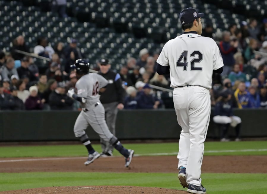 Seattle Mariners starting pitcher Yusei Kikuchi, right, watches as Cleveland Indians’ Jose Ramirez, left, rounds the bases after Ramirez hit a solo home run during the third inning of a baseball game, Monday, April 15, 2019, in Seattle. (AP Photo/Ted S.