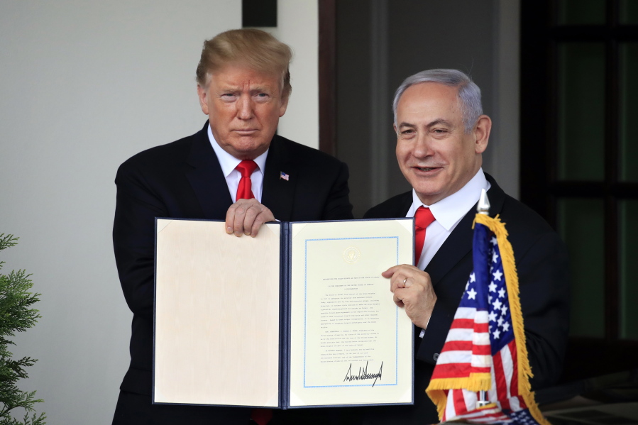 FILE - In this March 25, 2019 file photo, Israeli Prime Minister Benjamin Netanyahu and President Donald Trump hold up the signed proclamation recognizing Israel’s sovereignty over the Golan Heights at the White House in Washington. In a tight race for re-election, Netanyahu has gotten a welcome lift from his friend in the White House. Trump’s recognition of Jerusalem as Israel’s capital and the opening of the U.S. Embassy there, his withdrawal from the Iran nuclear deal and the decision to slash U.S. aid to the Palestinians are popular among Israelis.