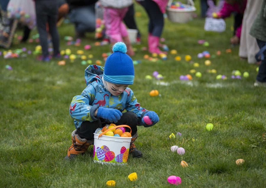 Jasper Poulton collects Easter eggs in Ridgefield during a 2018 egg hunt.