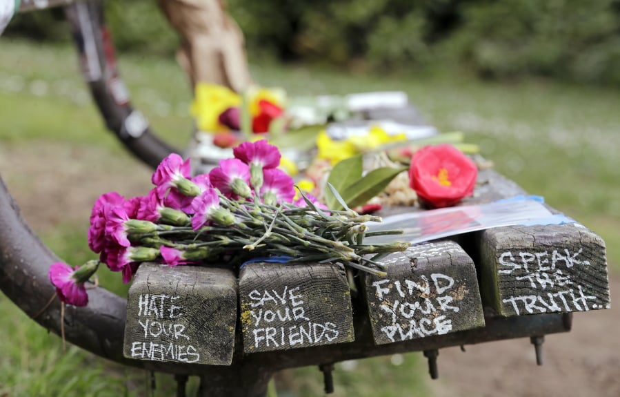 Flowers honoring the late Kurt Cobain appear on a park bench, Friday, April 5, 2019, in Seattle. People gathered throughout the day at Viretta Parkin in Seattle, Friday, leaving flowers, candles and written messages on the 25th anniversary of Cobain’s death. Cobain, whose band Nirvana rose to global fame amid Seattle’s grunge rock years of the early 1990s, shot himself on April 5, 1994 in his home near Lake Washington.