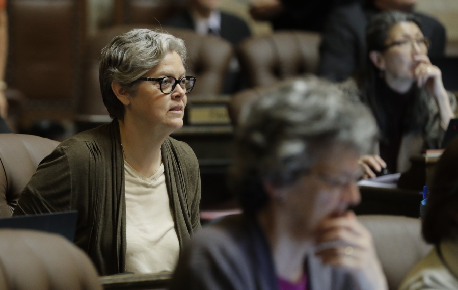 In this April 11, 2019 photo, Rep. Laurie Jinkins, D-Tacoma, listens to debate on the House floor at the Capitol in Olympia, Wash. Jinkins is the sponsor of a measure that has Washington poised to become the first state to establish an employee-paid program creating an insurance benefit to help offset the costs of long-term care, pending a final vote in the House. (AP Photo/Ted S.