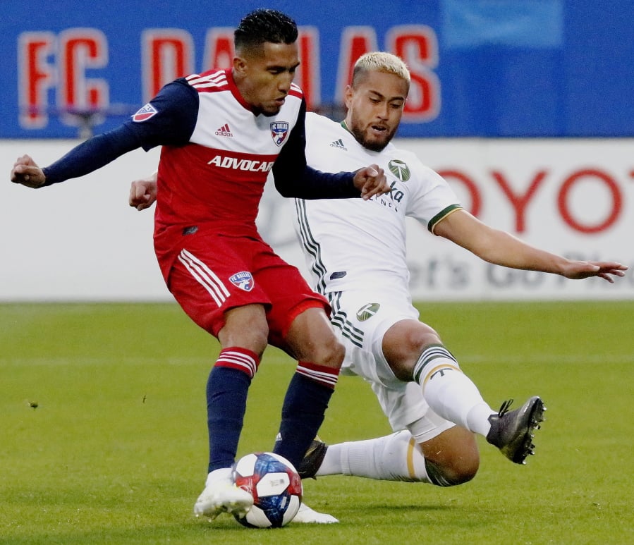 FC Dallas forward Jesus Ferreira, left, shoots for the first goal of the game as he is defended by Portland Timbers defender Bill Tuiloma (25) during the first half of an MLS soccer match in Frisco, Texas, Saturday, April 13, 2019. (Stewart F.