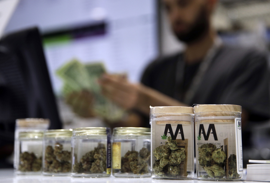 FILE - In this July 1, 2017, file photo, a cashier rings up a marijuana sale at the Essence cannabis dispensary in Las Vegas. Complaints that the state releases no information about who applies for and receives dispensary licenses in Nevada’s booming retail marijuana business are spurring lawsuits and legislative proposals that appear poised to push the process public.