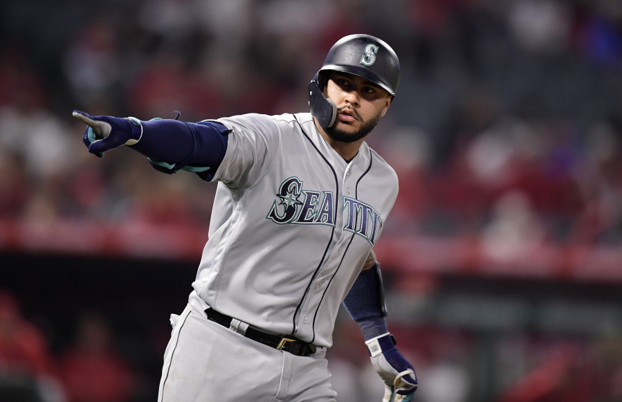 Seattle Mariners’ Omar Narvaez points to his dugout as he round first after hitting a solo home run during the ninth inning of the team’s baseball game against the Los Angeles Angels on Friday, April 19, 2019, in Anaheim, Calif. (AP Photo/Mark J.