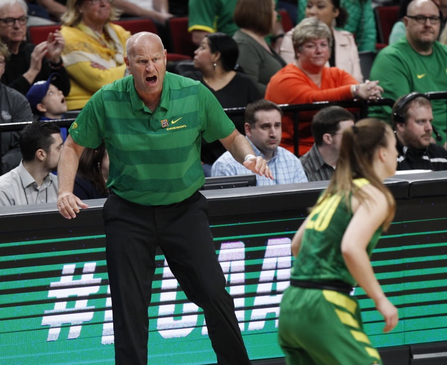 Oregon head coach Kelly Graves, left, shouts instructions to his team during the first half of a regional final against Mississippi State on Sunday in Portland. Graves led Oregon to its first Final Four, where the Ducks will join women’s basketball dynasties in UConn, Baylor and Notre Dame.