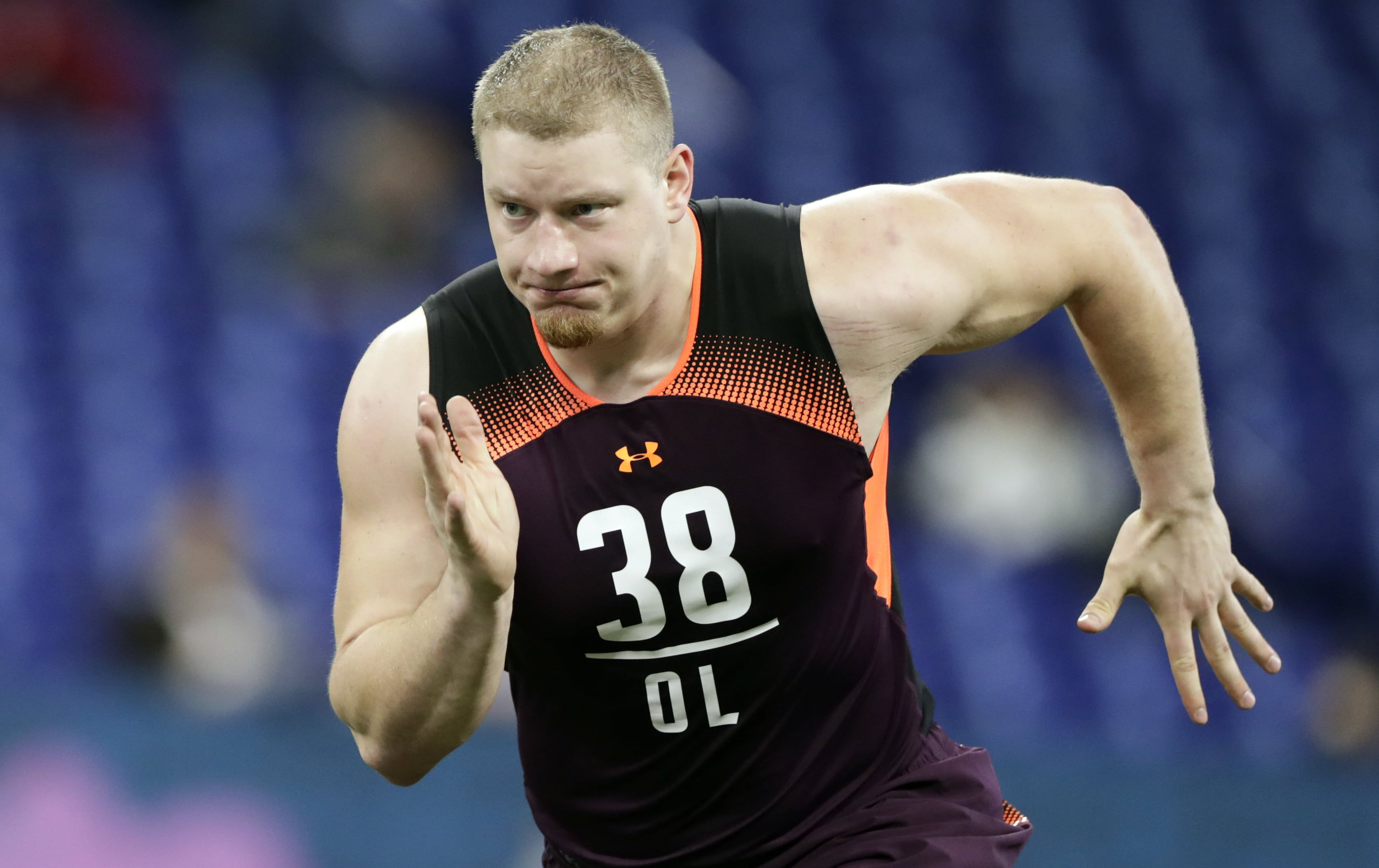 FILE - In this March 1, 2019, file photo, Washington offensive lineman Kaleb McGary runs a drill at the NFL football scouting combine in Indianapolis. McGary is a possible pick in the 2019 NFL Draft.