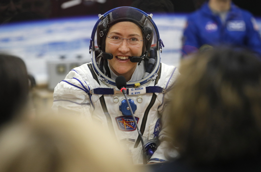 FILE - In this Thursday, March 14, 2019 file photo, U.S. astronaut Christina Koch, member of the main crew of the expedition to the International Space Station (ISS), speaks with her relatives through a safety glass prior the launch of Soyuz MS-12 space ship at the Russian leased Baikonur cosmodrome, Kazakhstan. Koch will remain on board until February, approaching but not quite breaking Scott Kelly’s 340-day U.S. record.