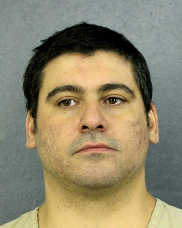 This Tuesday, April 10, 2019 photo made available by Broward County Sheriff’s office, Fla., shows Luis Alberto Ferri under arrest. Ferri turned himself in to authorities less than a week after investigators released a video showing him intentionally driving his vehicle into a pedestrian. The victim suffered a broken leg. Ferri is charged with aggravated battery.