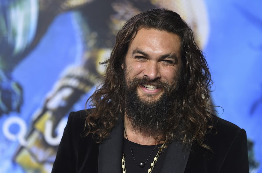 FILE - In this Dec. 12, 2018 file photo, Jason Momoa arrives at the premiere of “Aquaman” at TCL Chinese Theatre in Los Angeles. Momoa on Wednesday, April 17, 2019 released a video in which he shaved off his signature beard and mustache in order to promote recycling. He started by saying farewell to his “Game of Thrones” and DC characters Drogo and Arthur Curry. Momoa said he thought he last shaved in 2012.