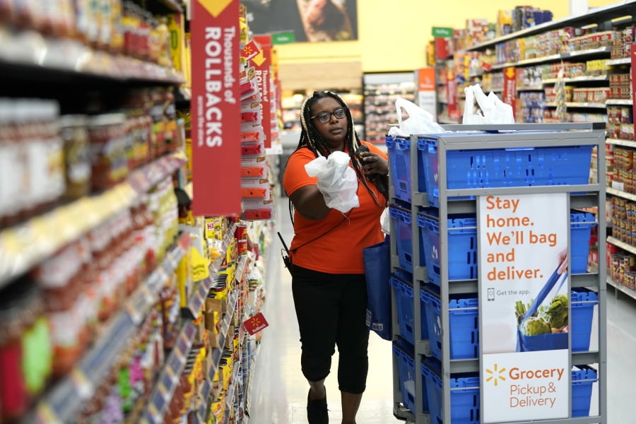 Walmart associate Alicia Carter fulfills online grocery orders at a Walmart Supercenter in November in Houston. David J.