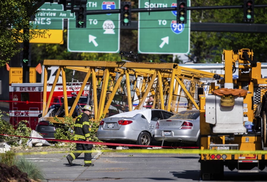 Emergency crews work the scene of a construction crane collapse near the intersection of Mercer Street and Fairview Avenue near Interstate 5 in Seattle, on Saturday, April 27, 2019. The crane was atop an office building under construction in a densely populated area. Authorities say several people have died and a few others are hospitalized after the construction crane fell onto a street in downtown Seattle pinning cars underneath on Saturday afternoon.