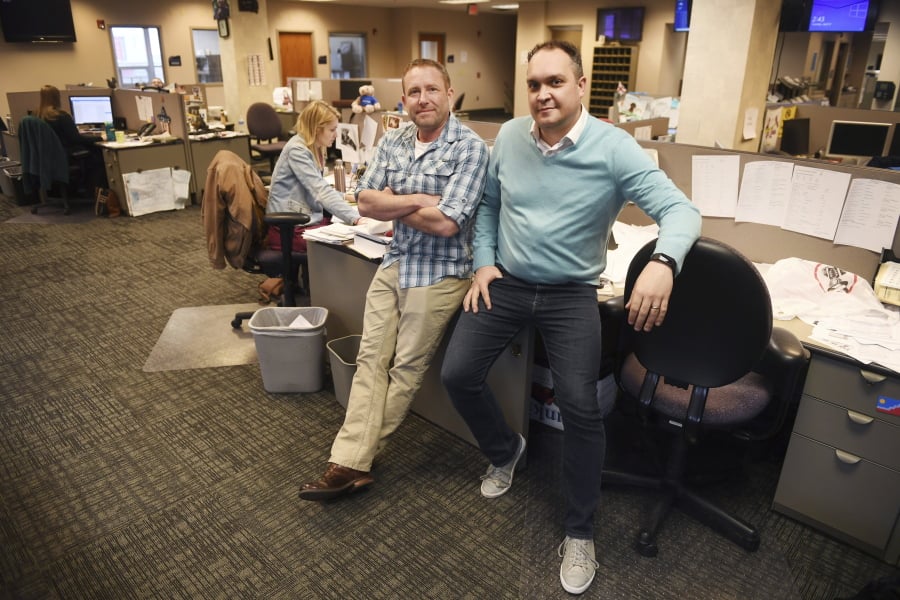 Argus Leader investigative reporter Jonathan Ellis, left, and news director Cory Myers stand the newsroom in Sioux Falls, S.D.