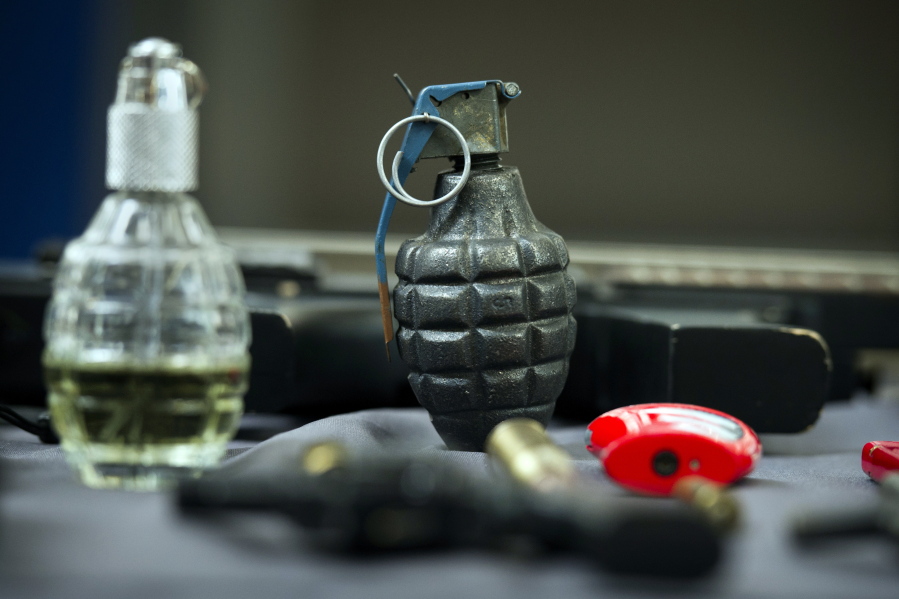 An inert hand grenade is seen along with other banned items taken from passengers at Transportation Security Administration (TSA) checkpoints at Dulles International Airport in Dulles, Va., Tuesday, March 26, 2019.