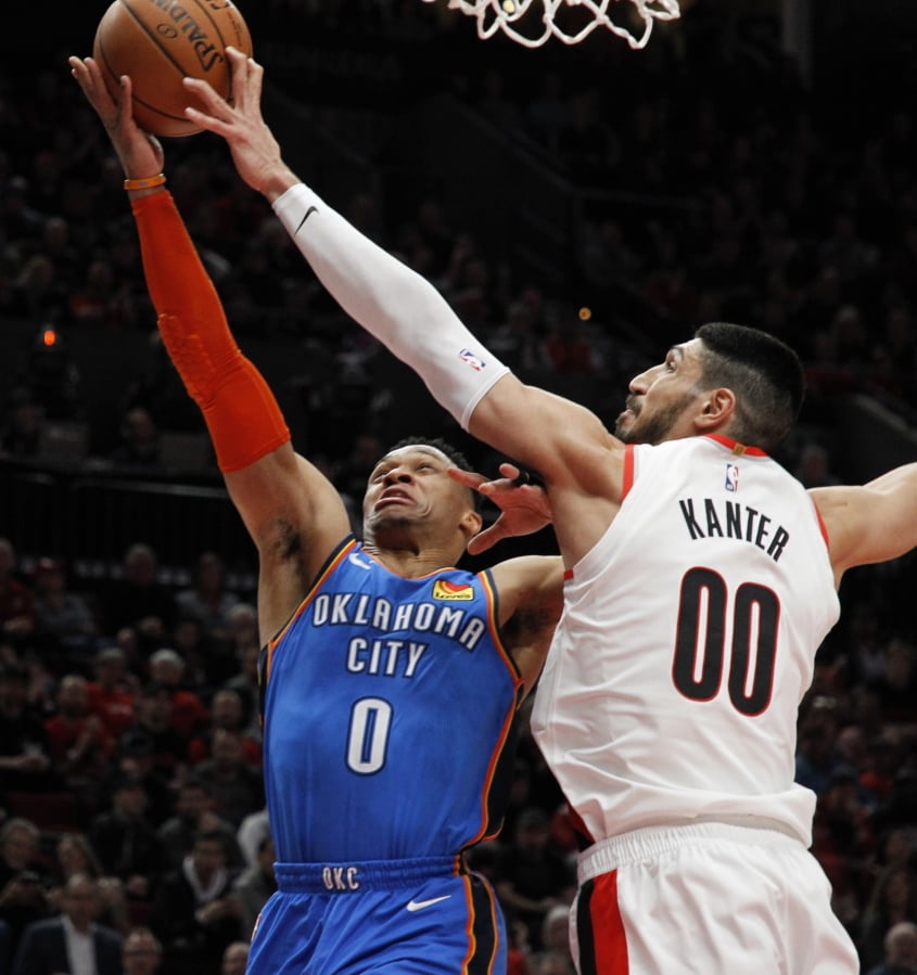 Oklahoma City Thunder guard Russell Westbrook, left, has his shot blocked by Portland Trail Blazers center Enes Kanter, right, during the first half of Game 1 of a first-round NBA basketball playoff series in Portland, Ore., Sunday, April 14, 2019.