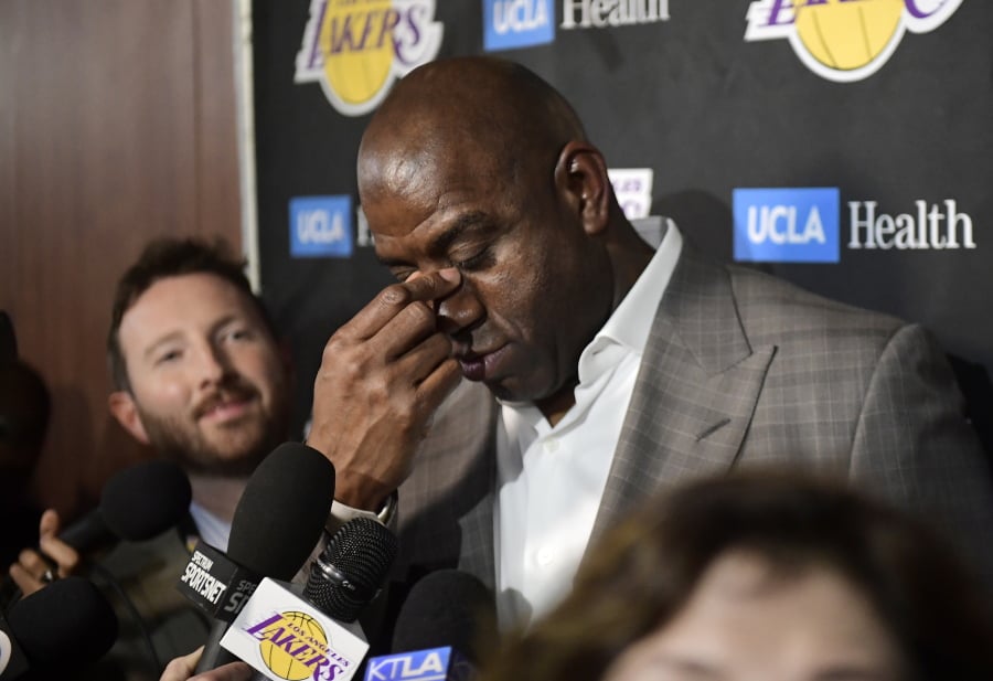 Magic Johnson wipes his eyes as he speaks to reporters prior to an NBA basketball game between the Los Angeles Lakers and the Portland Trail Blazers on Tuesday, April 9, 2019, in Los Angeles. Johnson abruptly quit as the Lakers' president of basketball operations Tuesday night, citing his desire to return to the simpler life he enjoyed as a wealthy businessman and beloved former player before taking charge of the franchise just over two years ago. (AP Photo/Mark J.