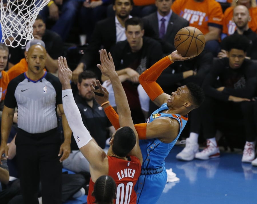 Oklahoma City Thunder guard Russell Westbrook, right, shoots in front of Portland Trail Blazers center Enes Kanter (00) I the first half of Game 3 of an NBA basketball first-round playoff series Friday, April 19, 2019, in Oklahoma City.