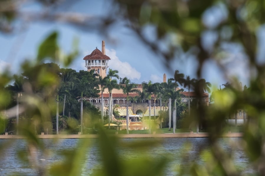 FILE - This Nov. 23, 2018 file photo shows President Donald Trump’s Mar-a-Lago estate behind mangrove trees in Palm Beach, Fla. On Saturday, March 30, 2019, a woman carrying two Chinese passports and a device containing computer malware lied to Secret Service agents and briefly gained admission to the club over the weekend during his Florida visit, federal prosecutors allege in court documents. (AP Photo/J.