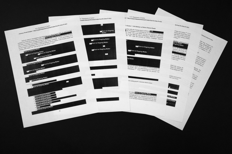 Special counsel Robert Mueller’s redacted report on the investigation into Russian interference in the 2016 presidential election is seen Thursday in Washington. These pages deal with Julian Assange and WikiLeaks.