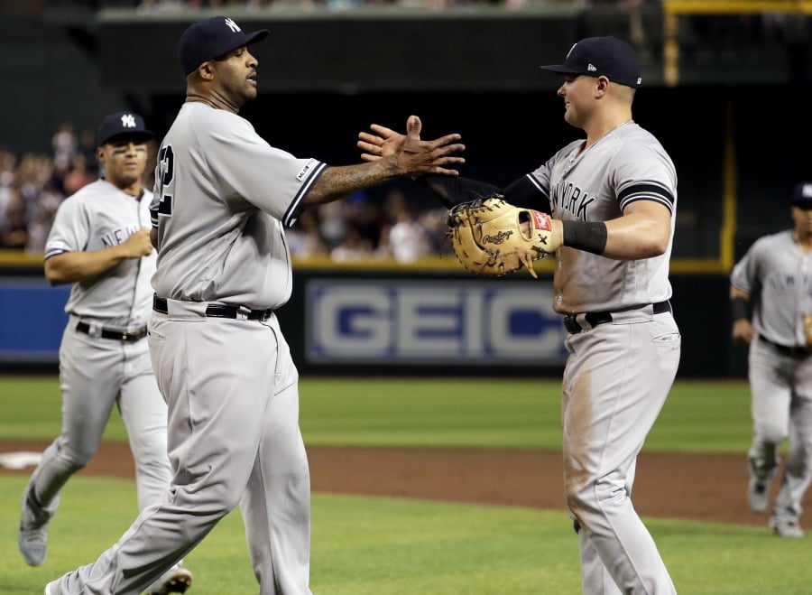 New York Yankees starting pitcher CC Sabathia, left, celebrates with first baseman Luke Voit after throwing his 3,000th career strikeout, during the second inning of the team’s baseball game against the Arizona Diamondbacks, Tuesday, April 30, 2019, in Phoenix.