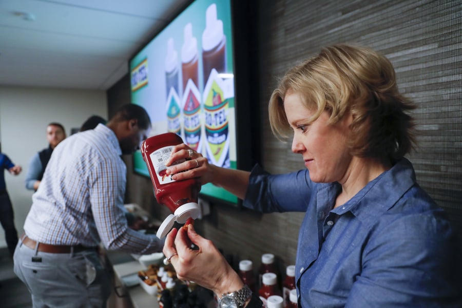 Jill Dexter, vice president and general manager over condiments, sauces and enhancers, tastes products at Conagra headquarters located in the Merchandise Mart in Chicago on Thursday, April 25, 2019. Conagra is flexing its muscle in the condiment aisle with a revamped Hunts ketchup, premium Hunts barbeque sauces and new lines of hot sauces from its Frontera and Ro-Tel brands. (Jose M.