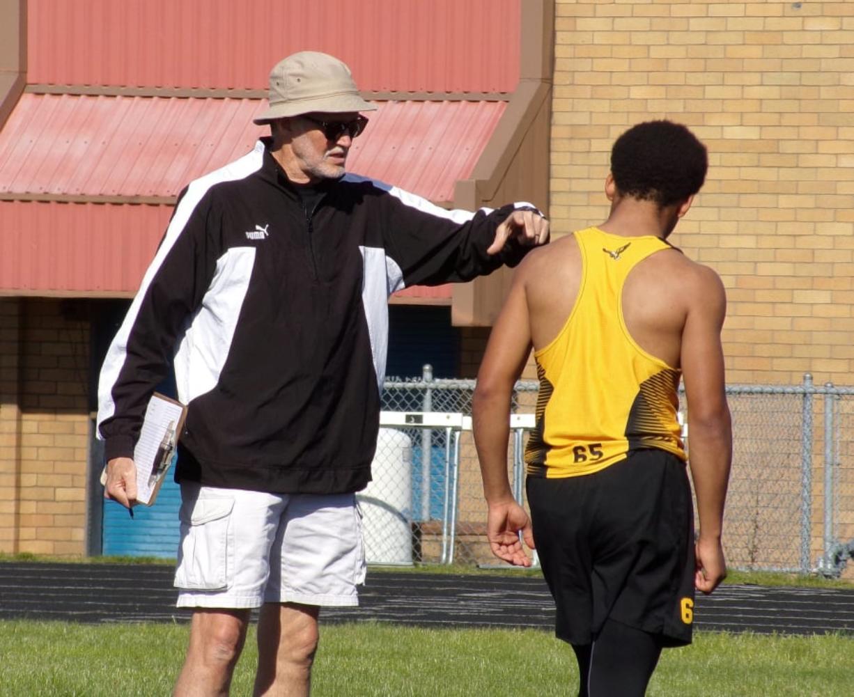 Hudson's Bay boys track and field coach Tom Petersen offers instruction to high jumper Jaden Lewis during a meet at Mountain View High School.