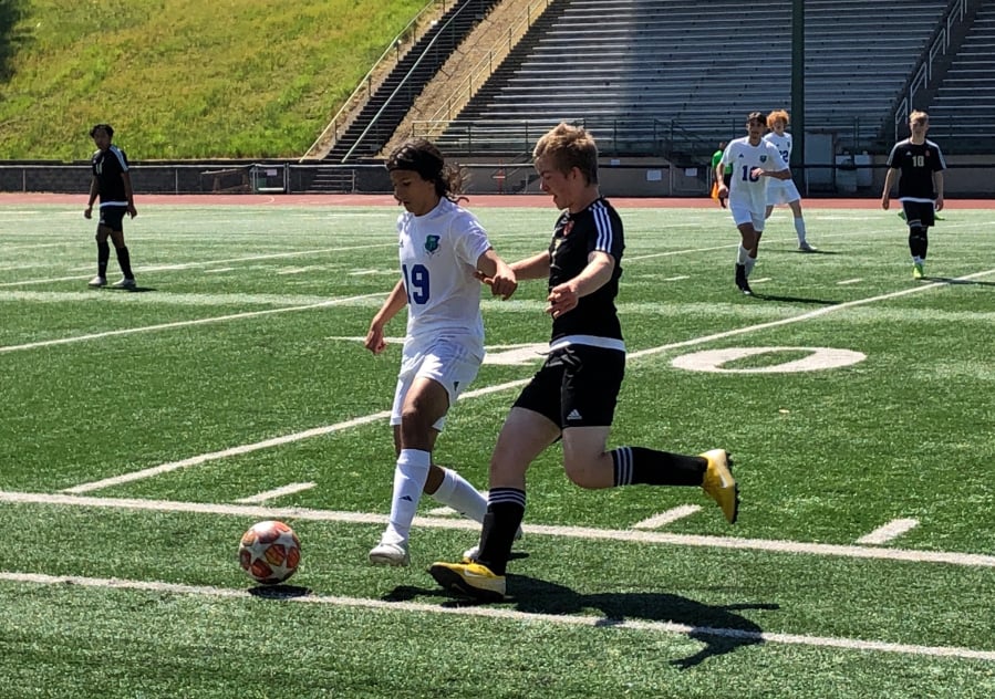 Mountain View midfielder Elijah Thompson (19) battles for the ball with Prairie midfielder Thomas Scruggs during a 3A bi-district soccer match on Saturday at McKenzie Stadium.