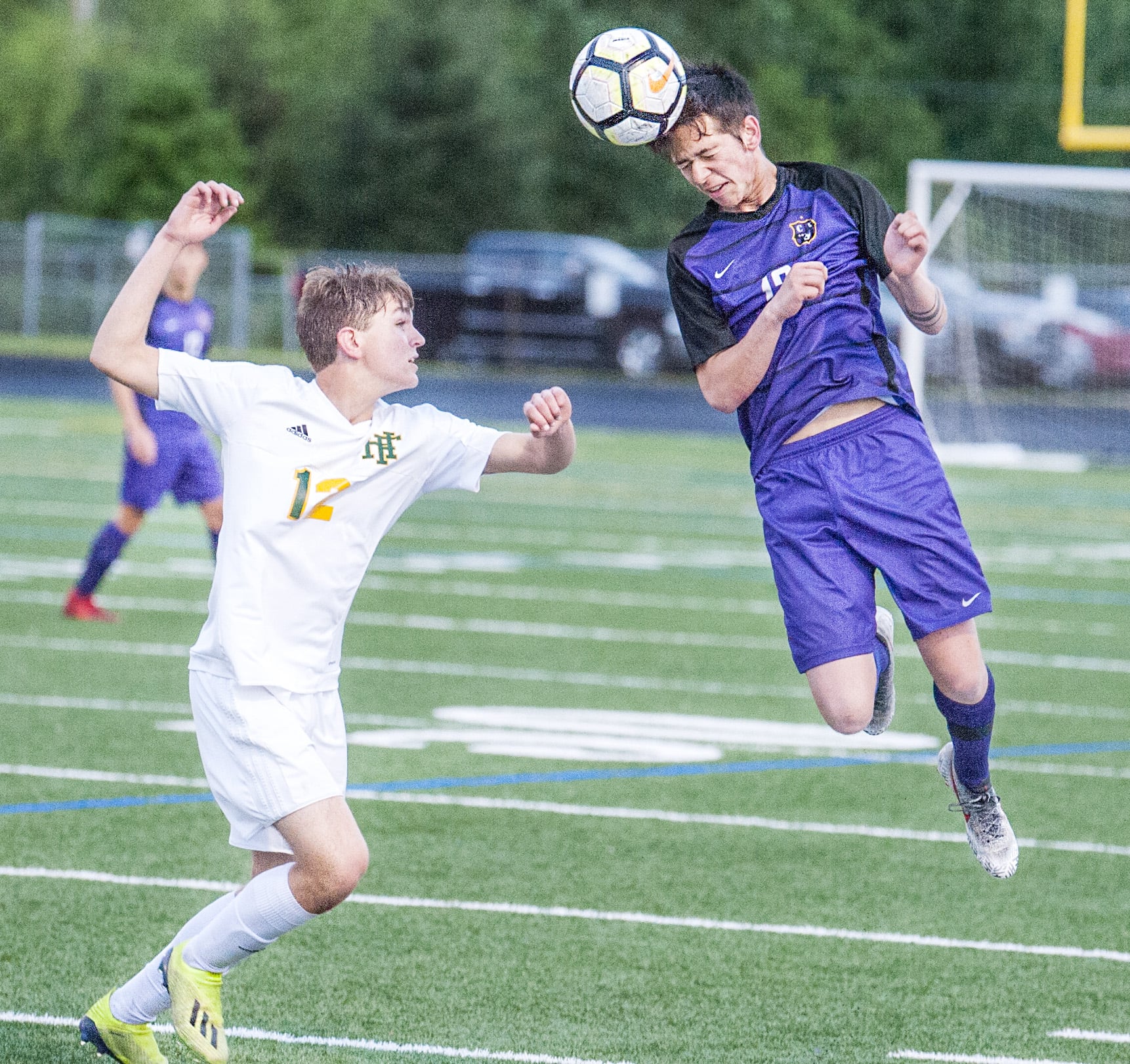 Columbia River's Alex Wiser heads the ball over Foss' Peter McKown in a 2A State first round game on Tuesday at Chieftain Stadium. Columbia River won 3-1.