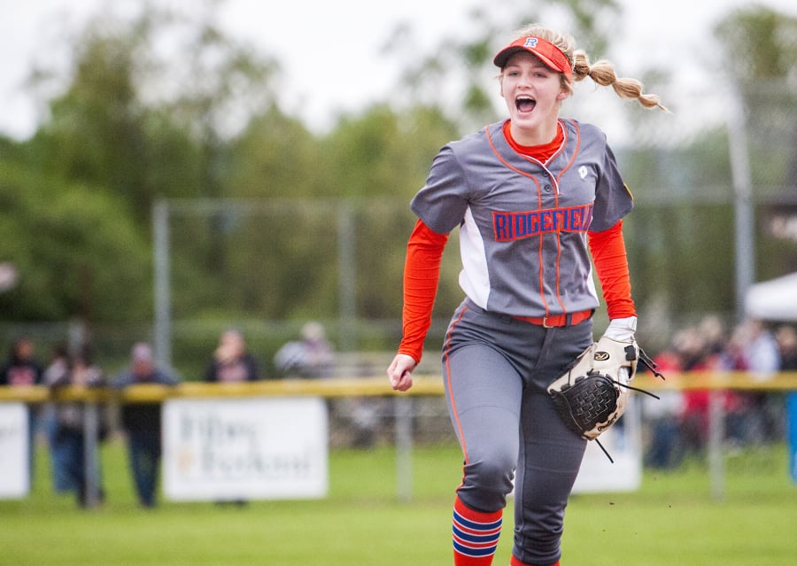 Ridgefield’s Kaia Oliver celebrates the final out of a 6-5 win over W.F. West on Friday, just two days after coach Dusty Anchors died from heart disease.